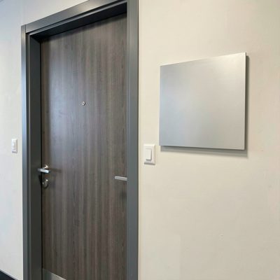 a professional office door with a blank wall plaque beside it, blank empty sign board, no text, no lettering, no logo