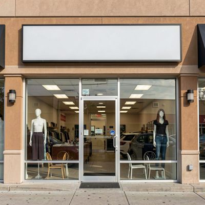 a strip mall unit with an empty sign band above the windows, blank empty sign board, no text, no lettering, no logo