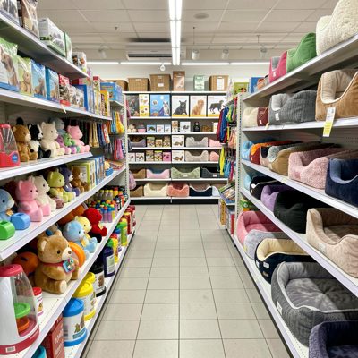 a pet shop aisle with toys and beds