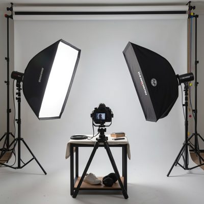 a studio with a softbox and a seamless backdrop