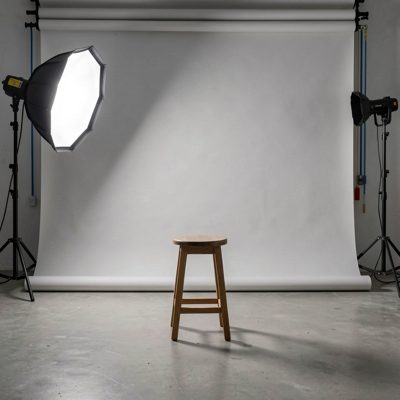a studio with a stool under a key light
