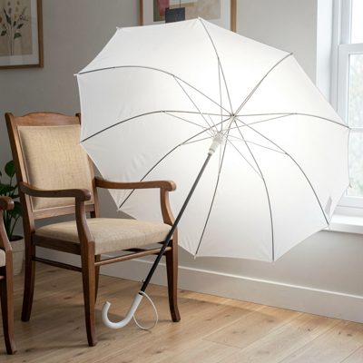 a white umbrella light beside a chair