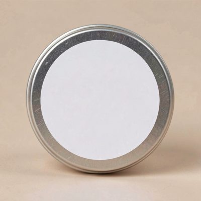 a small round balm tin with a blank white label