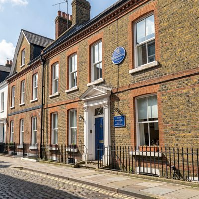 a listed building with a blue plaque