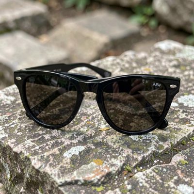 a pair of sunglasses on a stone surface