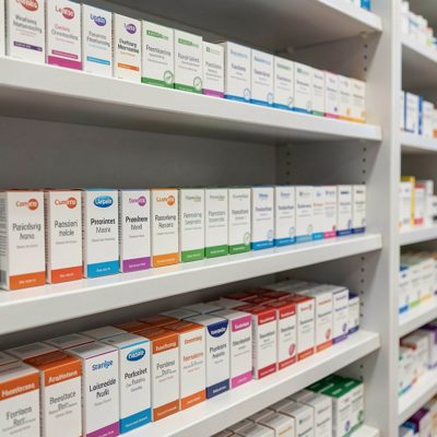 a pharmacy shelf with neatly faced boxes