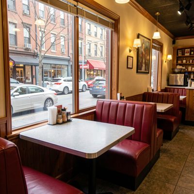 a diner booth with a window onto the street
