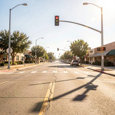 a hot dry street with a single traffic light
