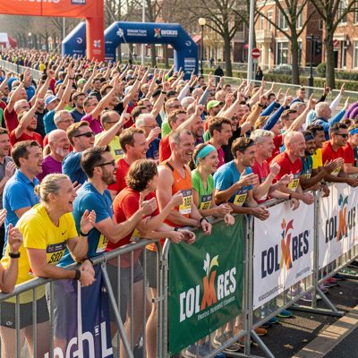 a marathon crowd cheering behind a barrier