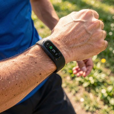 a fitness band on a wrist mid run