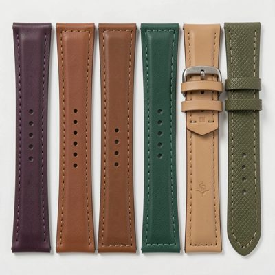 an assortment of watch straps laid out in a row