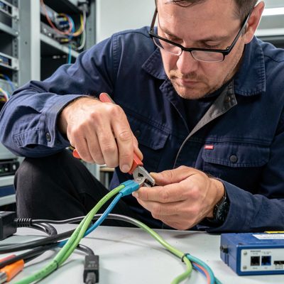 a technician crimping a network cable