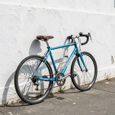 a bicycle leaning against a whitewashed wall