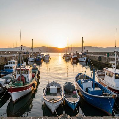 a harbour with fishing boats at first light