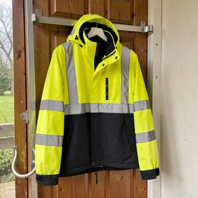 a hi vis jacket hanging on a rack by a door