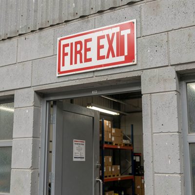 a fire exit sign above a warehouse door