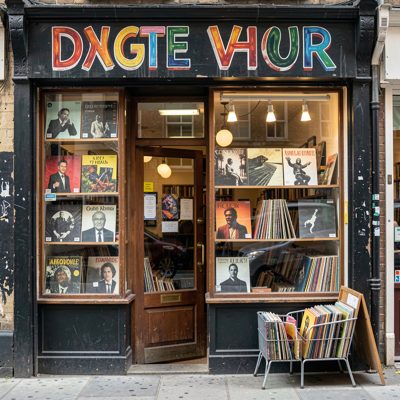 a record shop front with hand painted lettering