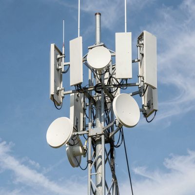 a wireless tower carrying sector panels and microwave dishes