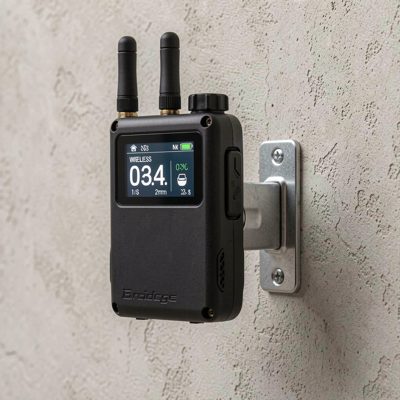 a wireless bridge radio mounted on a wall bracket