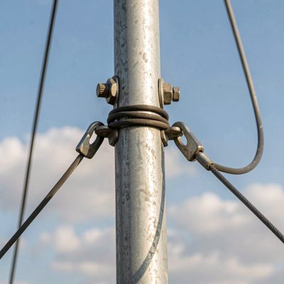 a grounding wire clamped to an antenna mast