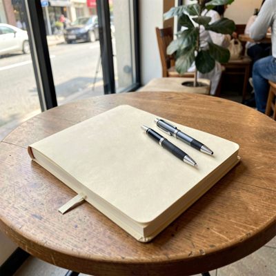 a notebook and pen on a cafe table