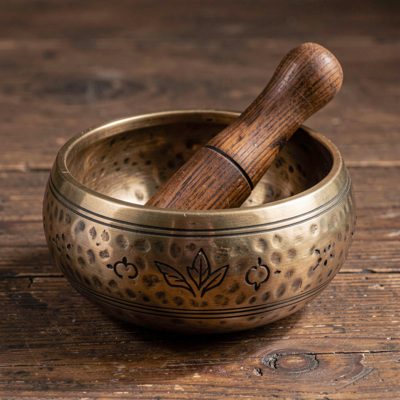 a singing bowl with a wooden striker